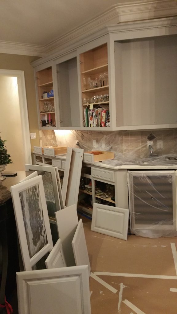 Kitchen cabinets being prepared for painting by interior painting services in Charlotte, NC.