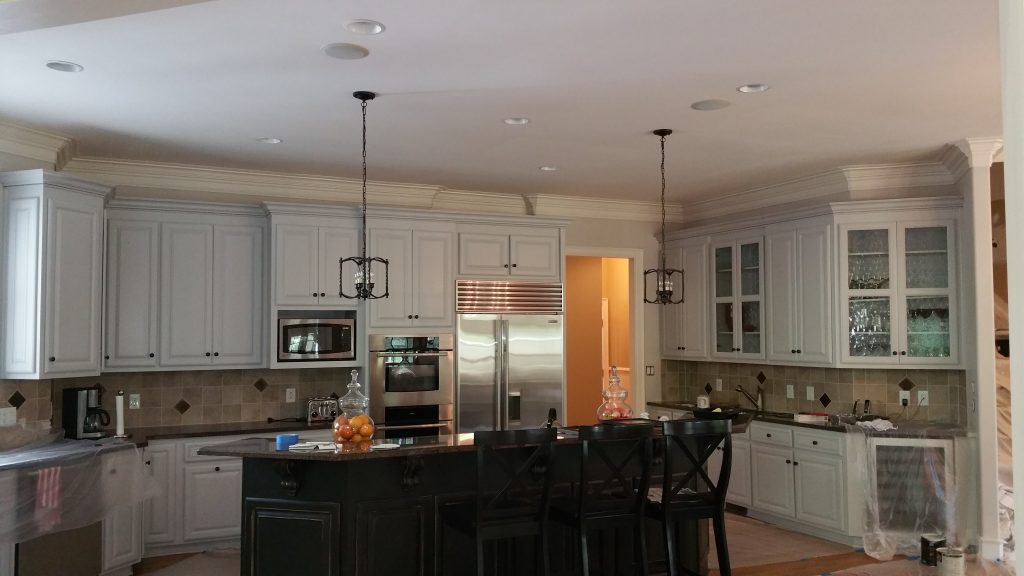 Freshly painted kitchen cabinets in a modern home showcasing Dubon Painting and More Inc.'s cabinet painting services in Charlotte, NC.