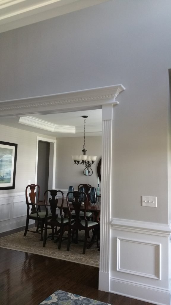 Dining area with elegant wainscoting and soft wall colors, demonstrating professional interior painting and cabinet painting in Charlotte, NC.