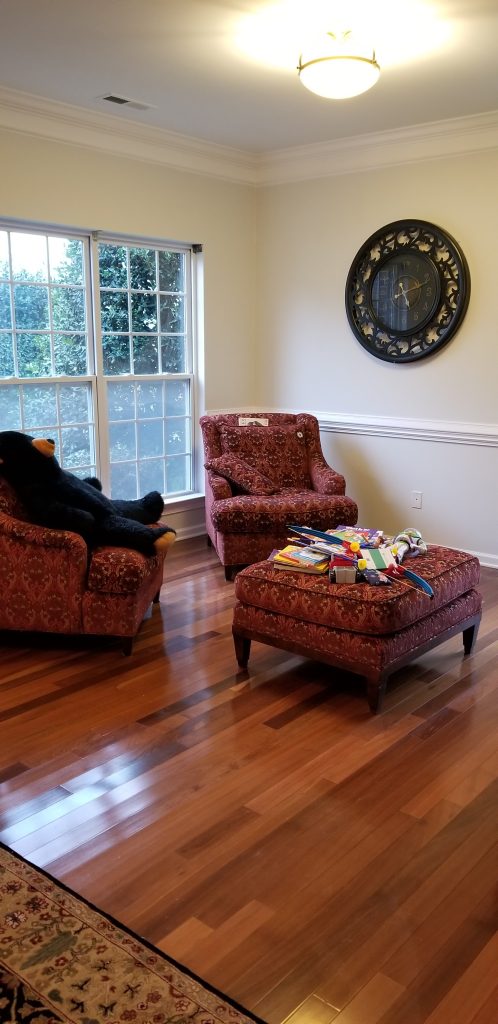 Bright and cozy living room with freshly painted walls and crown molding by Dubon Painting and More Inc.