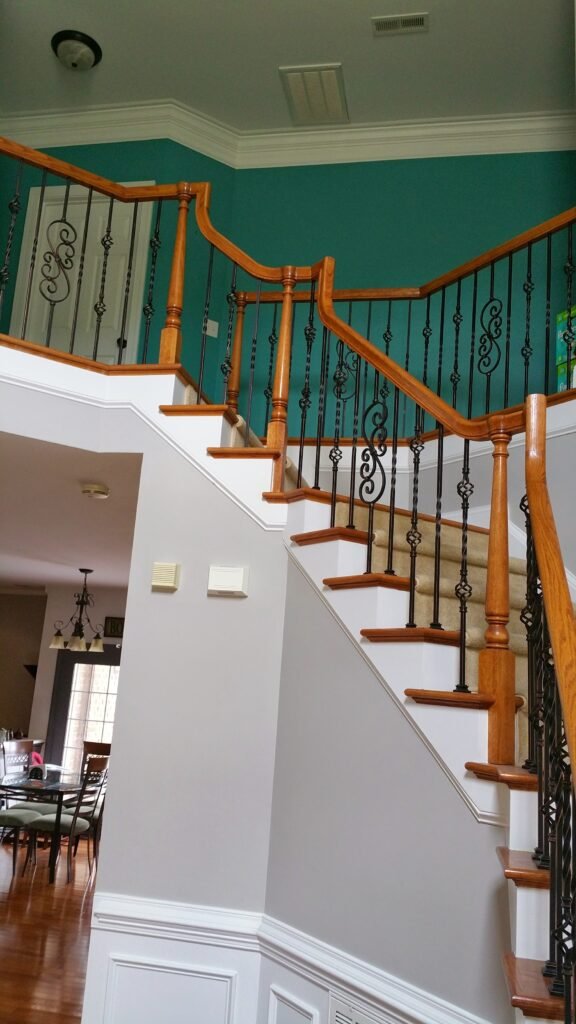 Interior staircase with vibrant walls painted by a professional painting company in Indian Land, SC.